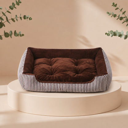 Cama nido para mascotas DELONEA SnoozePup de tela suave con patrón de rayas grises sobre una base circular.