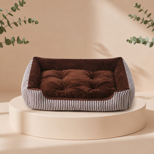 Cama nido para mascotas DELONEA SnoozePup de tela suave con patrón de rayas grises sobre una base circular.
