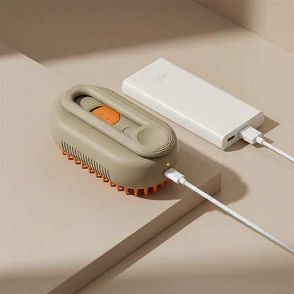 Cepillo de aseo DELONEA SteamPup 3 en 1 color beige con cerdas de silicona naranja cargándose vía USB